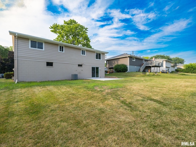 2922 W Larchmont Ln, Peoria, IL 61615 - back of property featuring a lawn, a patio, and stairway
