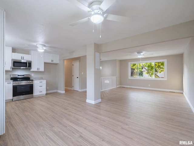 2922 W Larchmont Ln, Peoria, IL 61615 - kitchen featuring appliances with stainless steel finishes, open floor plan, a ceiling fan, and white cabinetry