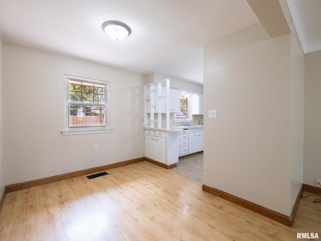 1505 N 9th St, Pekin, IL 61554 - unfurnished living room with light wood-style flooring and a sink