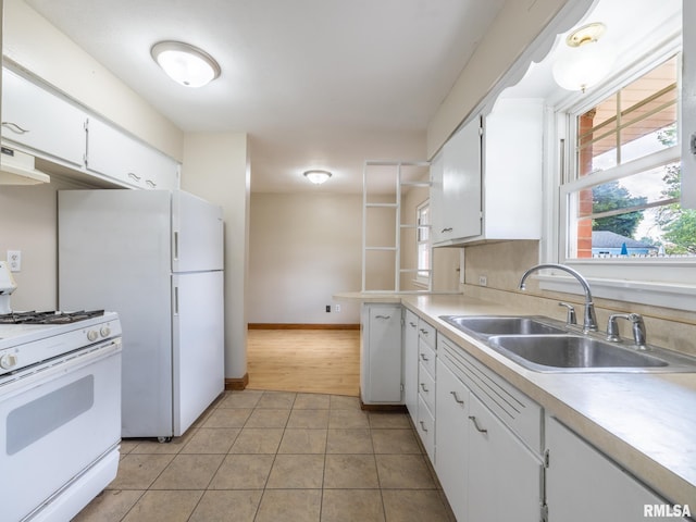 1505 N 9th St, Pekin, IL 61554 - kitchen featuring white appliances, under cabinet range hood, white cabinetry, light tile patterned flooring, and light countertops