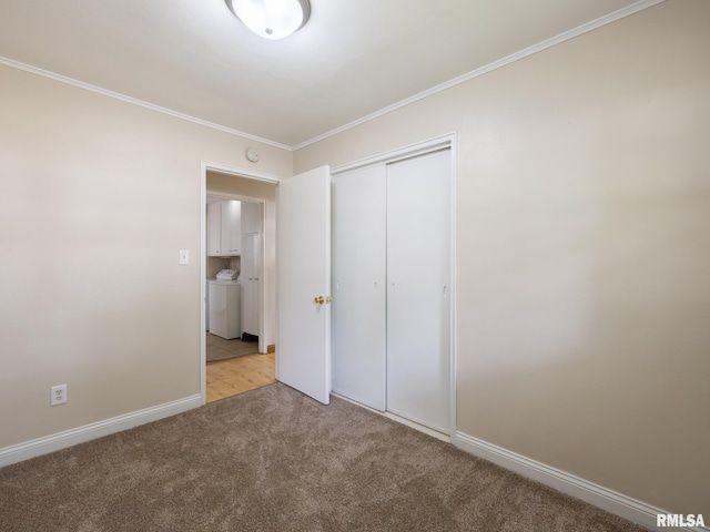 1505 N 9th St, Pekin, IL 61554 - unfurnished bedroom with light colored carpet, crown molding, washer / dryer, and a closet