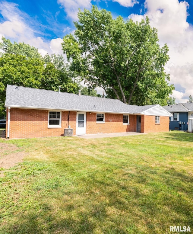 1505 N 9th St, Pekin, IL 61554 - back of house with brick siding, a lawn, and a shingled roof
