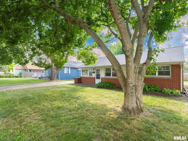 1505 N 9th St, Pekin, IL 61554 - ranch-style house with brick siding, a front yard, and a shingled roof