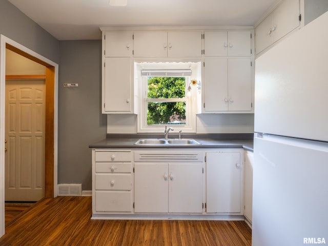 3 Starcevich Ct, Pekin, IL 61554 - kitchen with freestanding refrigerator, dark wood-style floors, white cabinets, and dark countertops