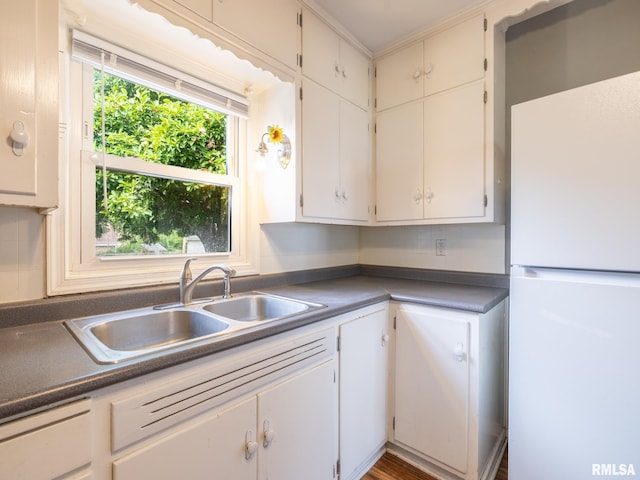 3 Starcevich Ct, Pekin, IL 61554 - kitchen featuring freestanding refrigerator, dark countertops, and white cabinets