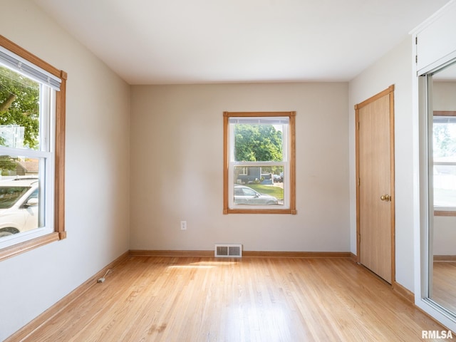 3 Starcevich Ct, Pekin, IL 61554 - unfurnished bedroom with light wood finished floors and multiple windows