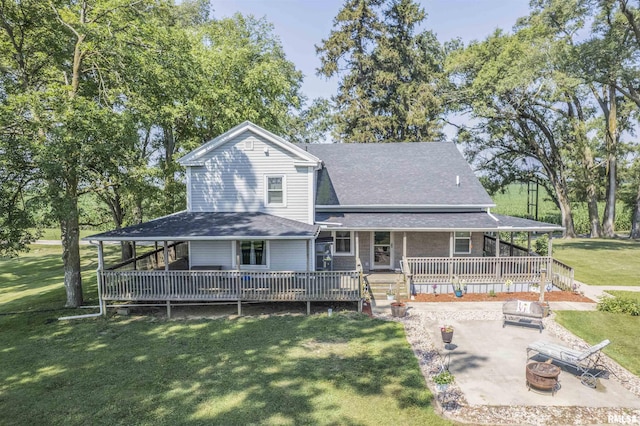 8373 State Route 93rd Rd, Toulon, IL 61483 - back of house featuring an outdoor fire pit, a lawn, a patio, and roof with shingles