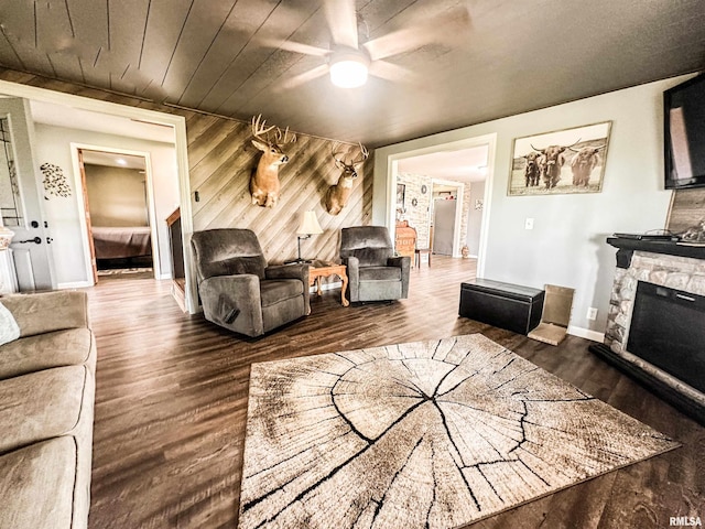 8373 State Route 93rd Rd, Toulon, IL 61483 - living area featuring ceiling fan, wood finished floors, wood walls, and a stone fireplace
