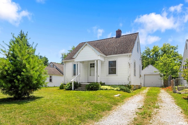 2046 W Wilson Ave, Peoria, IL 61604 - bungalow-style home featuring a shingled roof, a chimney, an outbuilding, a front lawn, and driveway