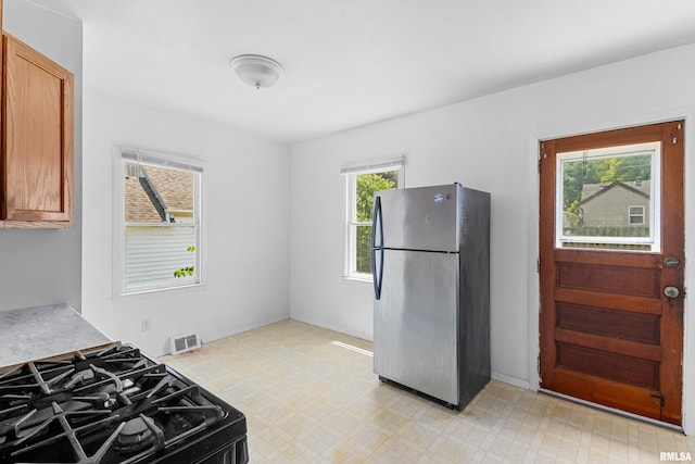 2046 W Wilson Ave, Peoria, IL 61604 - kitchen featuring freestanding refrigerator, light flooring, gas stove, and light countertops