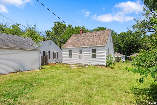 2046 W Wilson Ave, Peoria, IL 61604 - rear view of property with a yard and a chimney