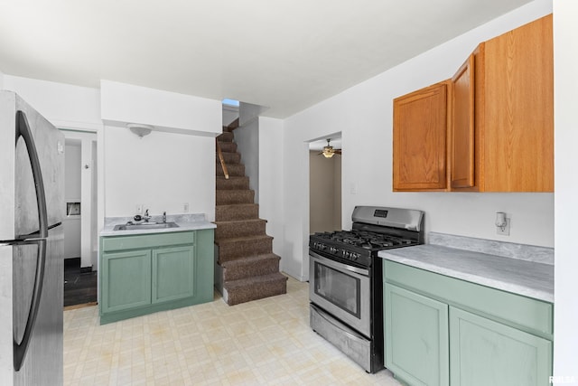 2046 W Wilson Ave, Peoria, IL 61604 - kitchen with appliances with stainless steel finishes, green cabinets, light countertops, light floors, and a ceiling fan