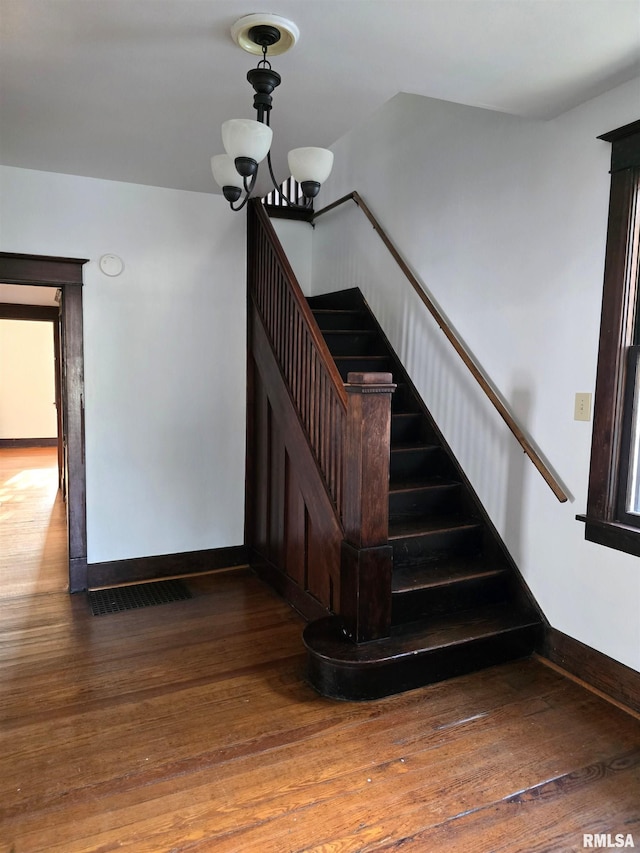 1113 S 5th St, Pekin, IL 61554 - staircase with hardwood / wood-style flooring and a chandelier