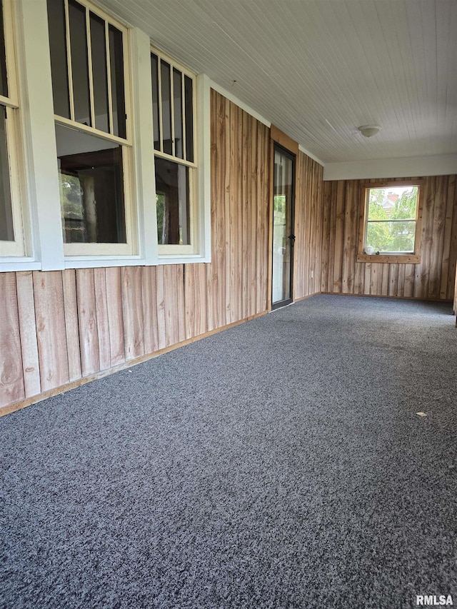 1113 S 5th St, Pekin, IL 61554 - carpeted spare room with wooden walls and wood ceiling