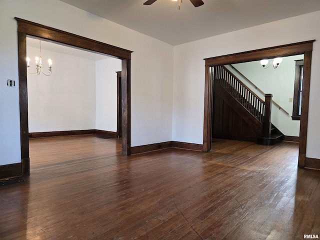 1113 S 5th St, Pekin, IL 61554 - unfurnished room featuring a chandelier, dark wood finished floors, stairway, and a ceiling fan