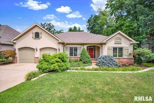 5615 W Timber Oak Ct, Peoria, IL 61615 - view of front facade with driveway, a front lawn, a garage, stucco siding, and brick siding