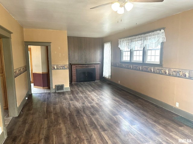 146 W Locust St, Canton, IL 61520 - unfurnished living room featuring ceiling fan, dark wood-type flooring, and a brick fireplace