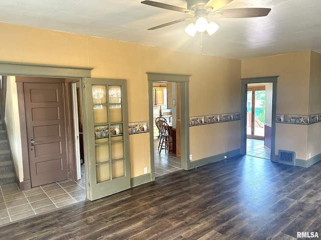 146 W Locust St, Canton, IL 61520 - empty room featuring wood finished floors, ceiling fan, and stairway