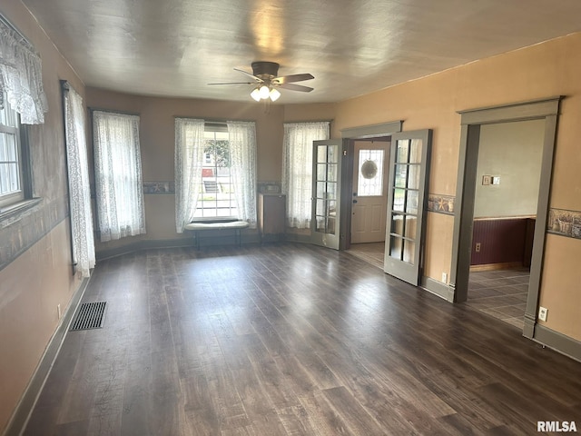 146 W Locust St, Canton, IL 61520 - unfurnished living room with wainscoting, wood finished floors, and ceiling fan