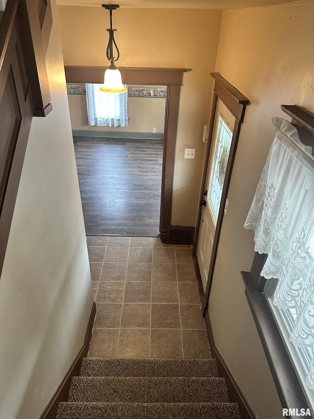 146 W Locust St, Canton, IL 61520 - stairs with tile patterned floors and baseboards