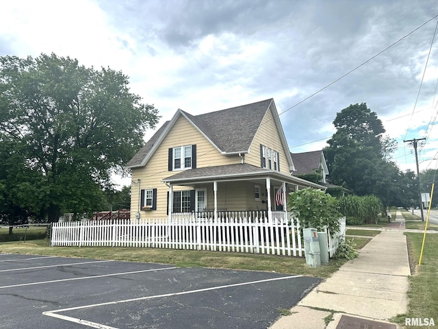 146 W Locust St, Canton, IL 61520 - view of front facade featuring uncovered parking, roof with shingles, and a porch