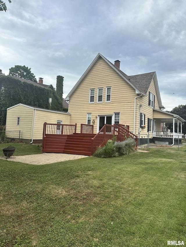 146 W Locust St, Canton, IL 61520 - rear view of property with a deck, a chimney, a patio, and a fire pit