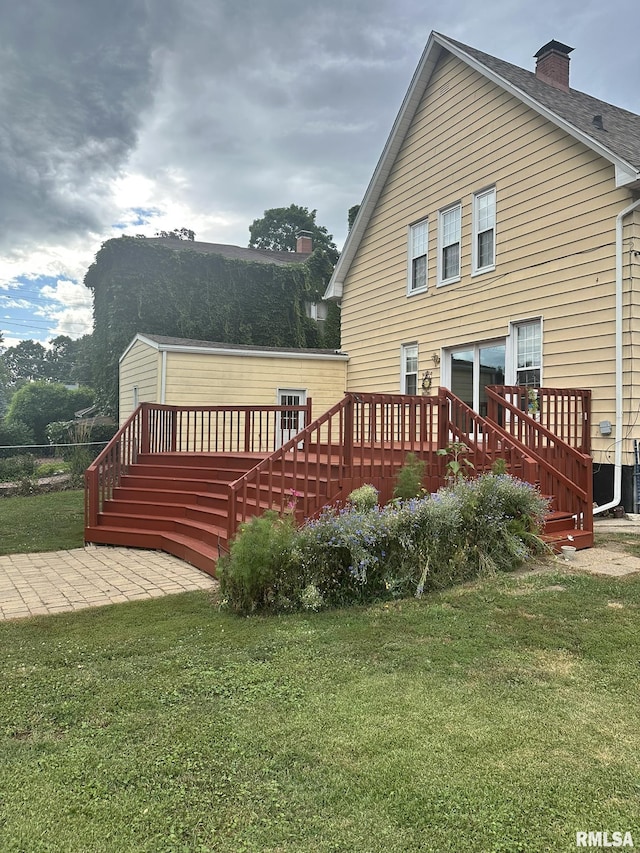 146 W Locust St, Canton, IL 61520 - rear view of property featuring a deck, a lawn, a chimney, a patio, and stairway