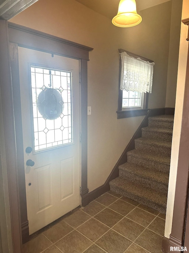 146 W Locust St, Canton, IL 61520 - entryway with dark tile patterned flooring and stairs