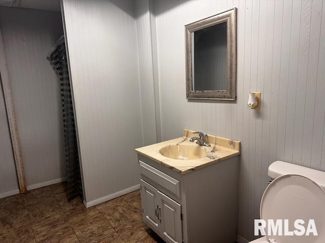 1415 E Sycamore St, Canton, IL 61520 - bathroom with vanity and wooden walls