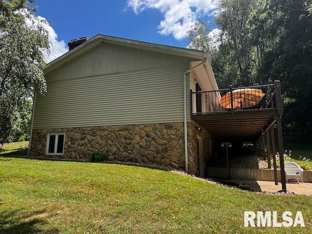 1415 E Sycamore St, Canton, IL 61520 - view of side of property featuring a yard, a wooden deck, stone siding, and a chimney