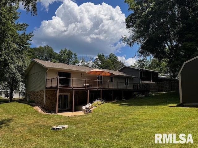 1415 E Sycamore St, Canton, IL 61520 - rear view of house with a yard, a wooden deck, a patio area, and stone siding