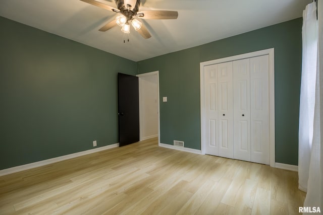 2129 Fondulac Dr, East Peoria, IL 61611 - unfurnished bedroom with light wood-style floors, a closet, and a ceiling fan