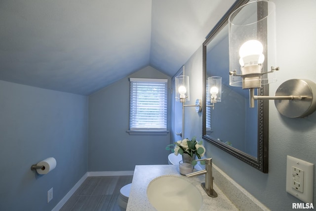 2129 Fondulac Dr, East Peoria, IL 61611 - bathroom featuring lofted ceiling and vanity