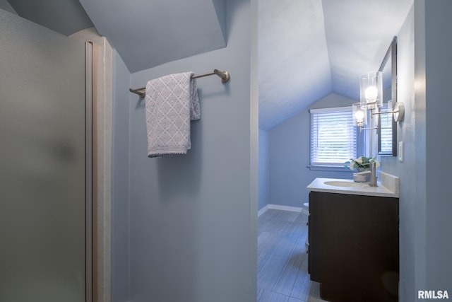 2129 Fondulac Dr, East Peoria, IL 61611 - bathroom featuring vanity, lofted ceiling, an enclosed shower, and wood finished floors