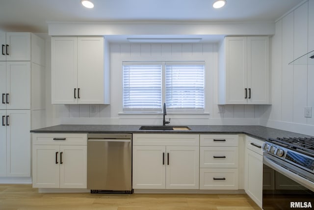 2129 Fondulac Dr, East Peoria, IL 61611 - kitchen featuring appliances with stainless steel finishes, white cabinetry, light wood finished floors, recessed lighting, and crown molding