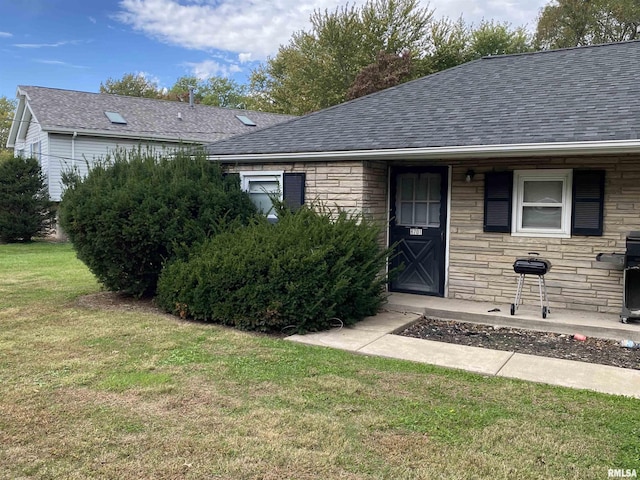 8701-8703 N Picture Ridge Rd, Peoria, IL 61615 - entrance to property with stone siding, a shingled roof, and a yard