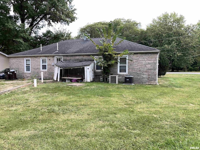 8701-8703 N Picture Ridge Rd, Peoria, IL 61615 - rear view of property featuring stone siding, a yard, and a shingled roof