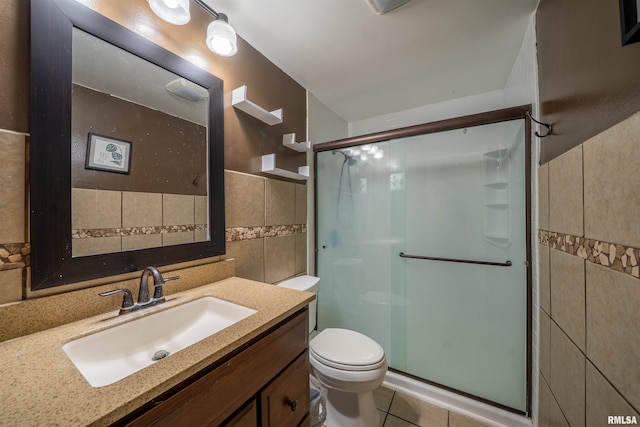 6822 N Kimberly Dr, Peoria, IL 61614 - bathroom with tile walls, a stall shower, vanity, and tile patterned floors