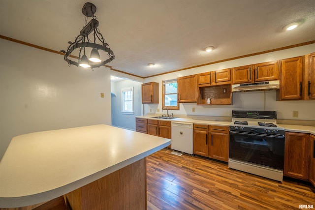 1025 E Maywood Ave, Peoria, IL 61603 - kitchen with white appliances, under cabinet range hood, ornamental molding, dark wood-style flooring, and brown cabinets