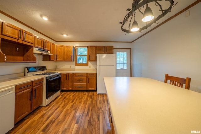 1025 E Maywood Ave, Peoria, IL 61603 - kitchen with white appliances, under cabinet range hood, wood finished floors, ornamental molding, and brown cabinets