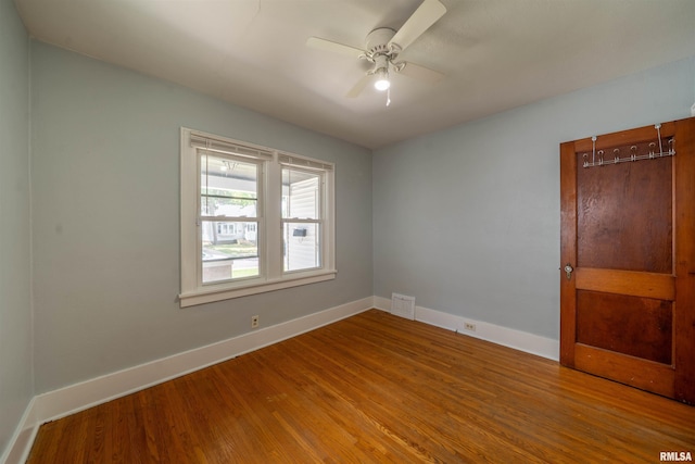 1025 E Maywood Ave, Peoria, IL 61603 - empty room with wood finished floors and a ceiling fan