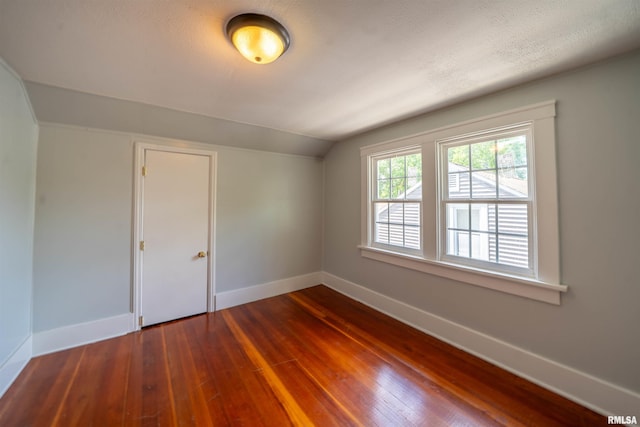 1025 E Maywood Ave, Peoria, IL 61603 - empty room featuring vaulted ceiling and dark wood finished floors