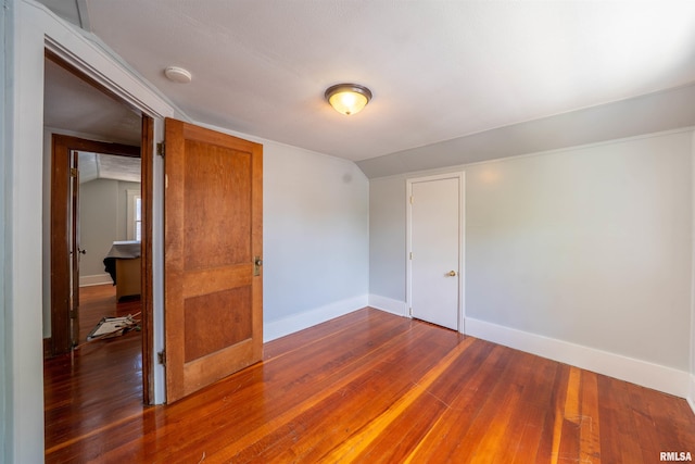 1025 E Maywood Ave, Peoria, IL 61603 - unfurnished room featuring wood-type flooring, a smoke detector, and vaulted ceiling
