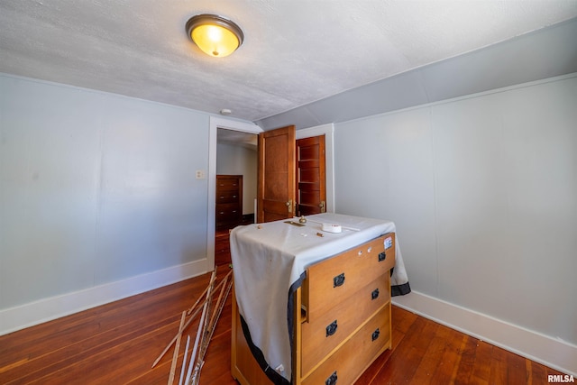 1025 E Maywood Ave, Peoria, IL 61603 - bedroom with baseboards and dark wood-style flooring