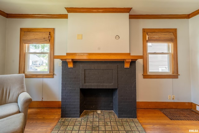 1025 E Maywood Ave, Peoria, IL 61603 - living area featuring crown molding, wood finished floors, and a brick fireplace