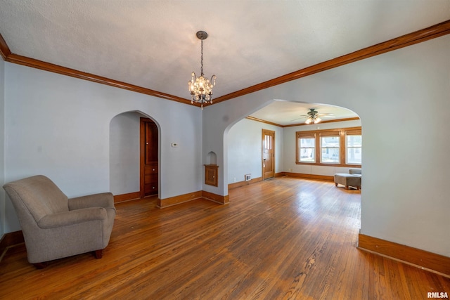 1025 E Maywood Ave, Peoria, IL 61603 - spare room featuring arched walkways, ornamental molding, hardwood / wood-style flooring, a chandelier, and a ceiling fan