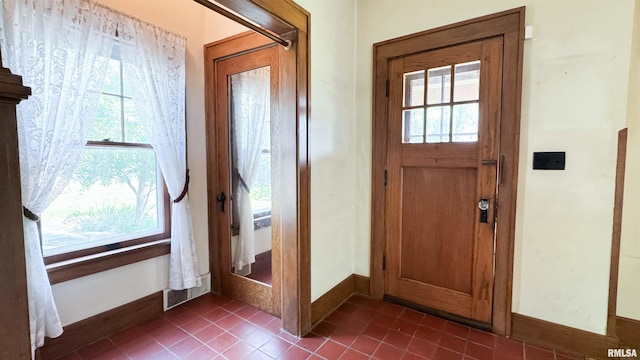 1113 N Summit Blvd, Peoria, IL 61606 - entryway with dark tile patterned floors and baseboards