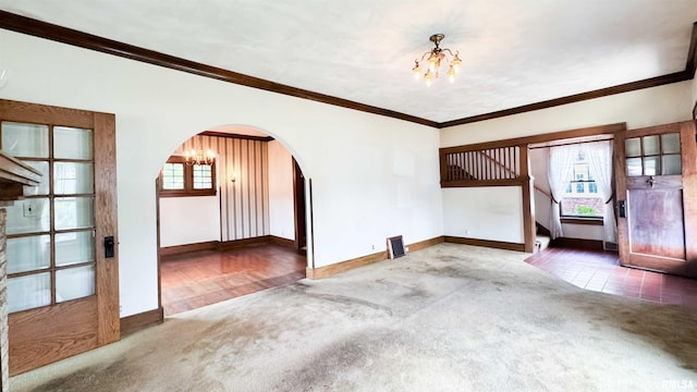 1113 N Summit Blvd, Peoria, IL 61606 - unfurnished room featuring a chandelier, carpet floors, crown molding, arched walkways, and stairs