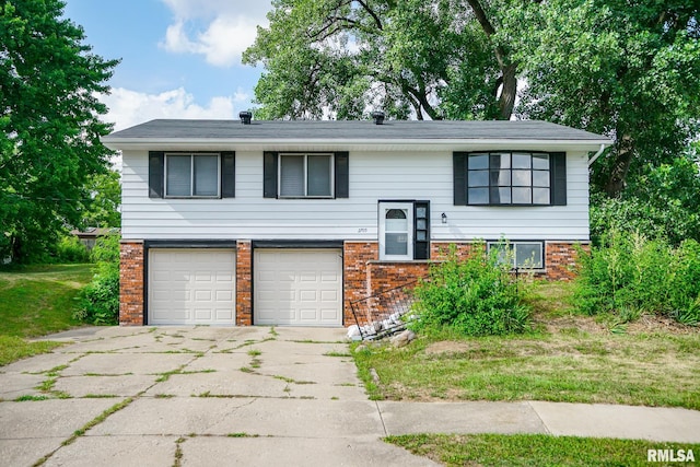 2705 W Millbrook Ct, Peoria, IL 61615 - raised ranch with brick siding, a garage, and concrete driveway