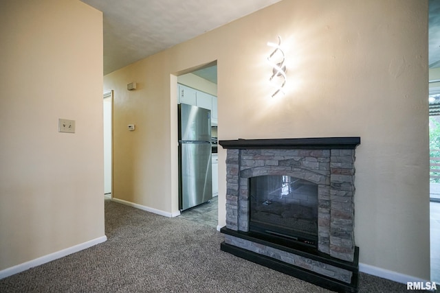 2705 W Millbrook Ct, Peoria, IL 61615 - unfurnished living room with carpet and a stone fireplace